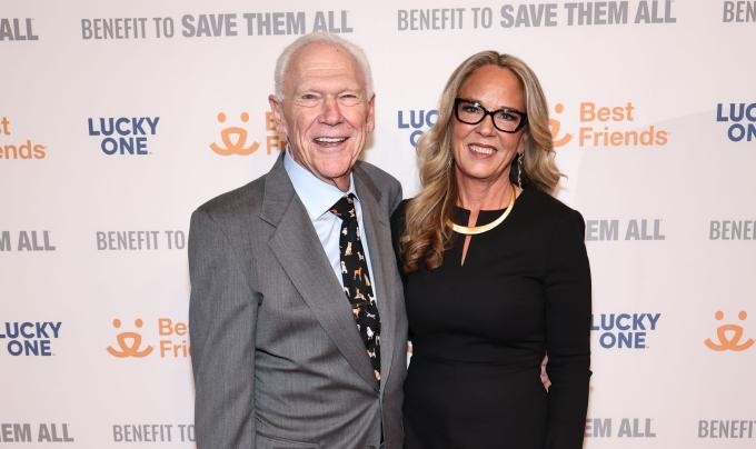 Rich Avanzino and Julie Castle in front of a Best Friends Benefit to Save Them All backdrop